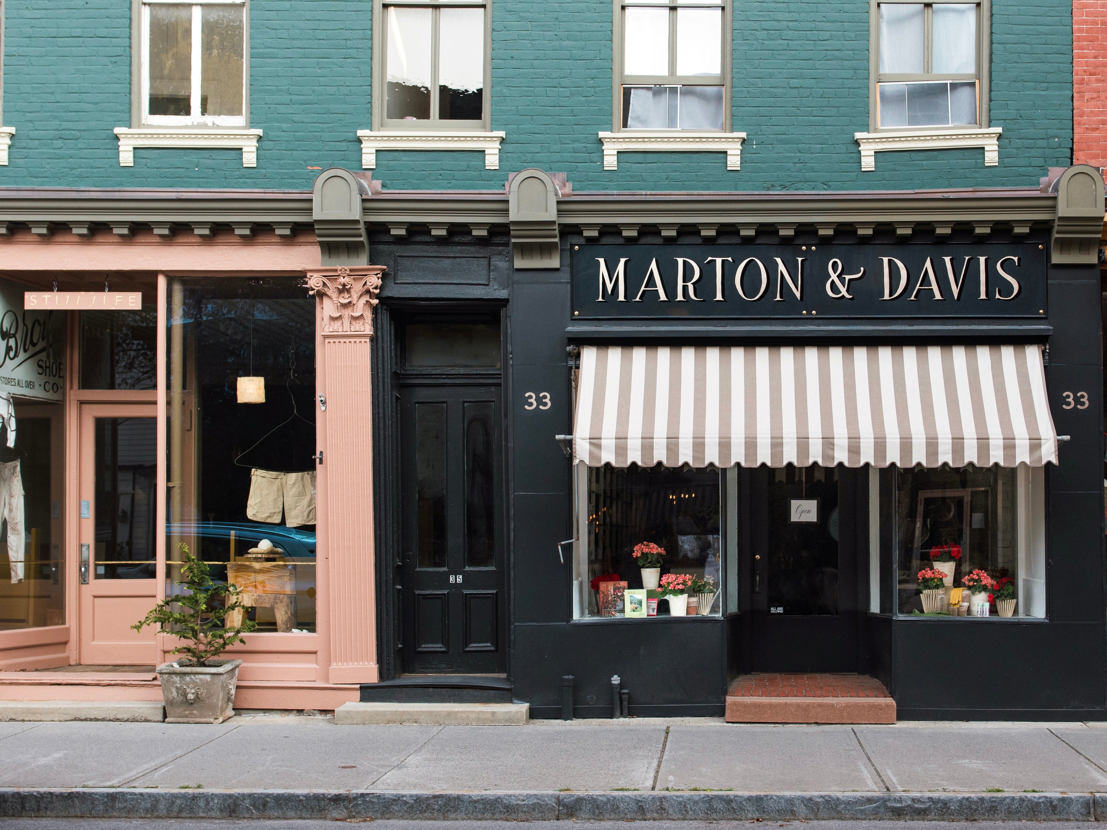 Storefront with 'Marton & Davis' sign and striped awning